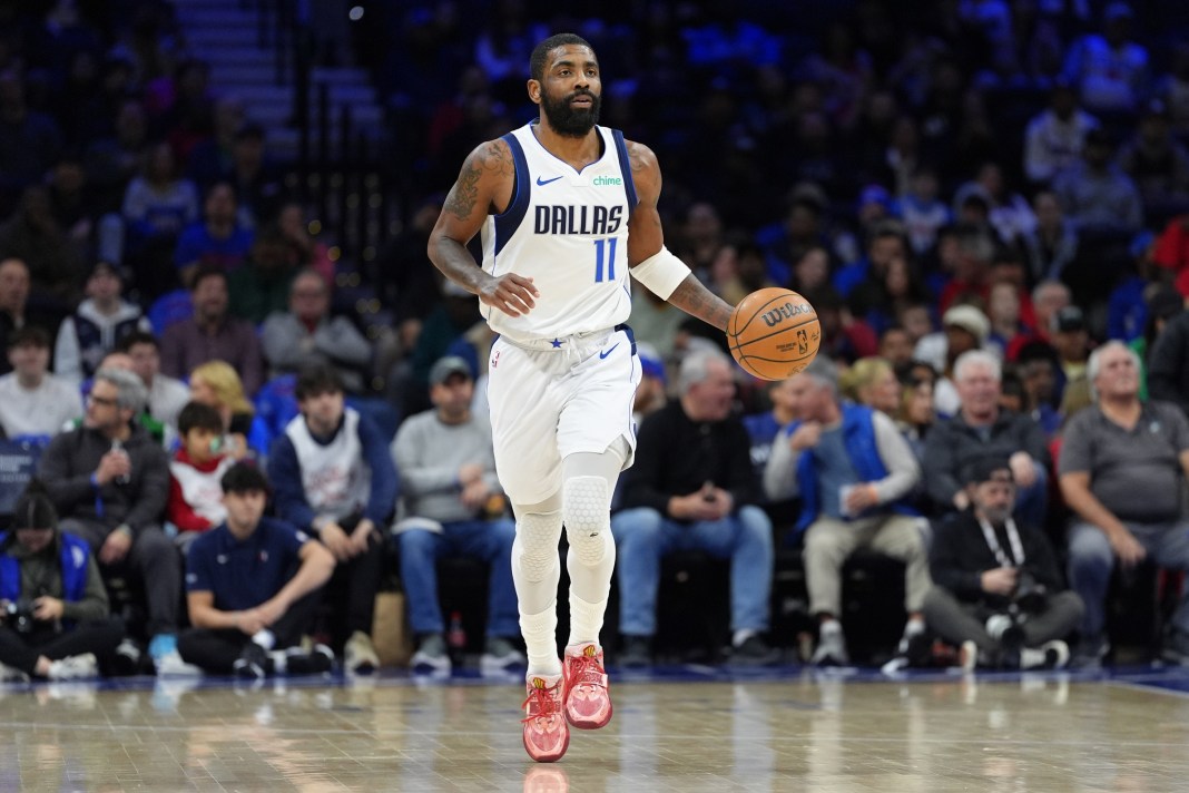 Mavericks star Kyrie Irving brings the ball up against the 76ers during the 2024-25 NBA season.