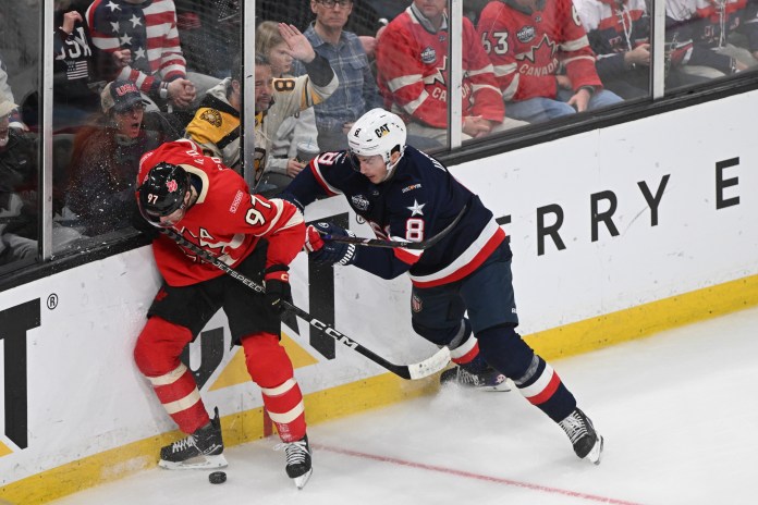 Team USA defenseman Zach Werenski (8) battles for the puck against Team Canada forward Connor McDavid (97) during the third period of the 4 Nations Face-Off ice hockey championship game at TD Garden on February 20, 2025.
