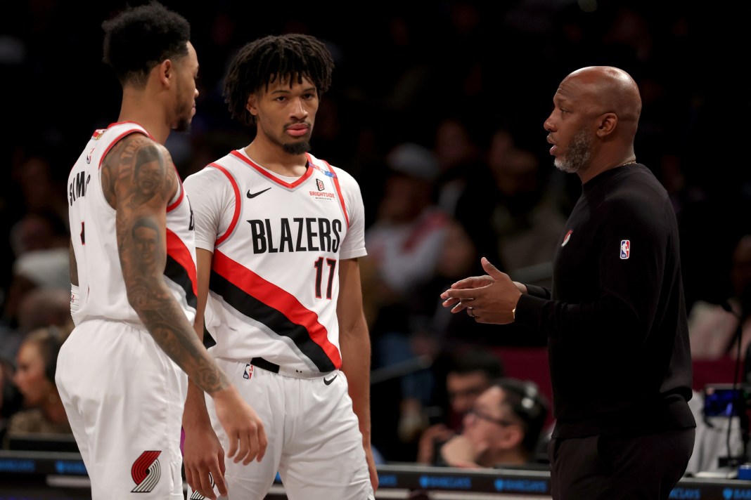 Blazers guards Anfernee Simons and Shaedon Sharpe listen to Chauncey Billups during the 2024-25 NBA season.