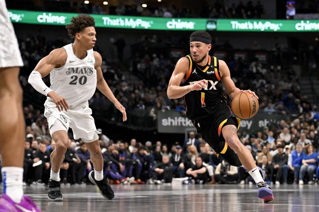 Suns star Devin Booker drives to the basket against the Mavericks during the 2024-25 NBA season.