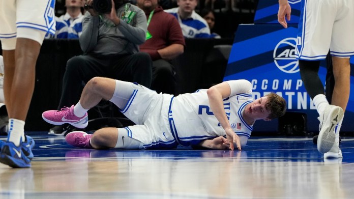 Duke Blue Devils forward Cooper Flagg (2) is injured in the first half at Spectrum Center on March 13, 2025.
