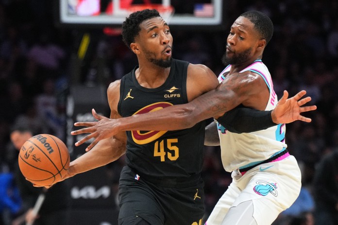 Miami Heat forward Haywood Highsmith (24) gets tied up with Cleveland Cavaliers guard Donovan Mitchell (45) during the first half of the game at Kaseya Center in Miami, Florida, on January 29, 2025.