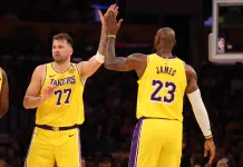 NBA Picks & Predictions Today (March 23): Best Bets on Sides & Totals Lakers superstars Luka Doncic and LeBron James high five during a meeting with the Timberwolves in the 2024-25 NBA season.