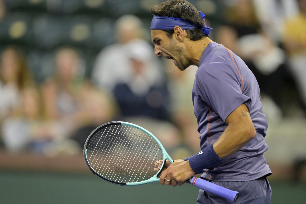 Lorenzo Musetti celebrates winning a set against Arthur Fils at the BNP Paribas Open in Indian Wells in 2025.