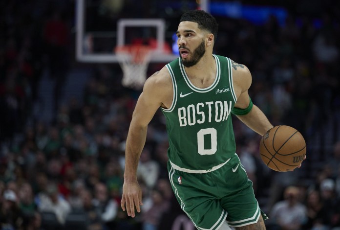 Celtics star Jayson Tatum dribbles against the Blazers during the 2024-25 NBA season.