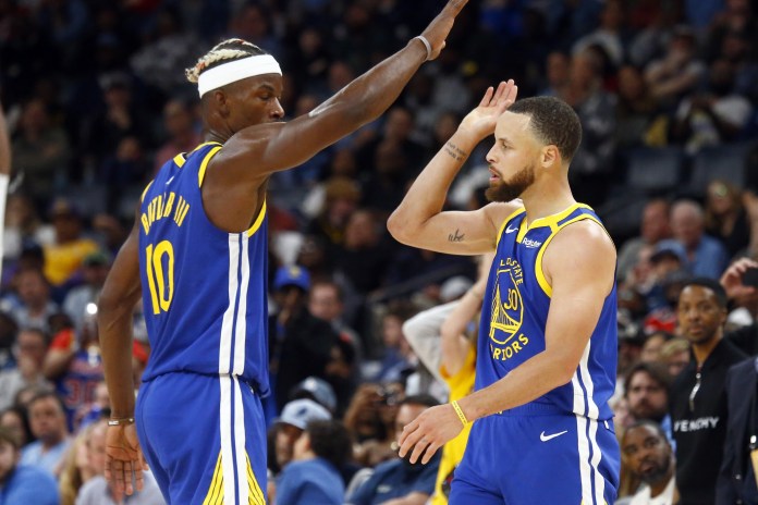 Warriors stars Steph Curry and Jimmy Butler celebrate a play against the Grizzlies during the 2024-25 NBA season.