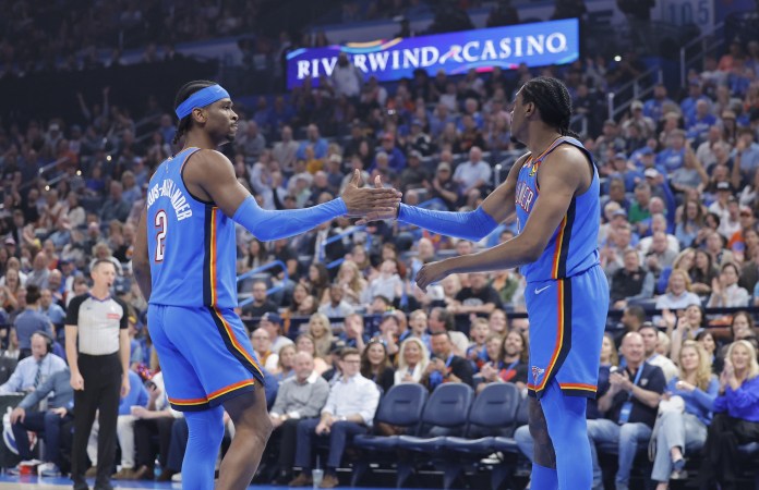 Thunder stars Shai Gilgeous-Alexander and Jalen Williams celebrate a play against the Pistons during the 2024-25 NBA season.