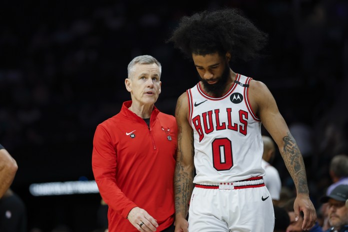 Bulls coach Billy Donovan talks to guard Coby White during a meeting with the Hornets in the 2024-25 NBA season.