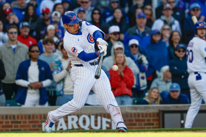 Chicago Cubs designated hitter Seiya Suzuki (27) hits an RBI single during the seventh inning of the game against the Philadelphia Phillies at Wrigley Field in Chicago, Illinois, on April 26, 2025.