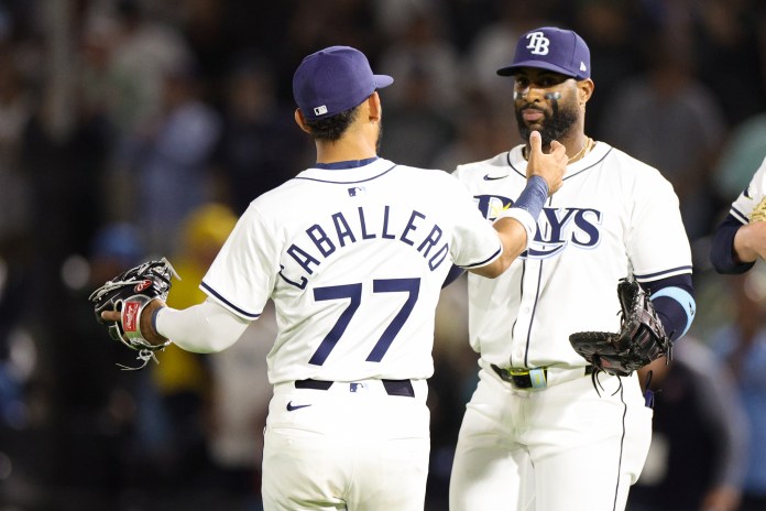 Tampa Bay Rays right fielder Jose Caballero (77) celebrates with first baseman Yandy Diaz (2) after defeating the Los Angeles Angels at George M. Steinbrenner Field in Anaheim, California, on April 9, 2025.