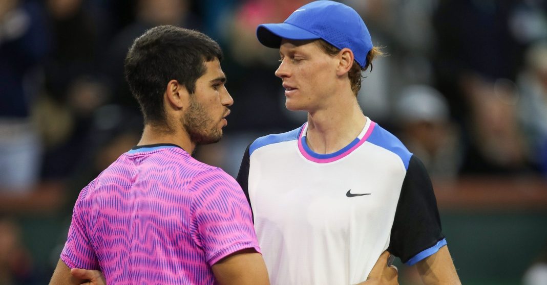 Carlos Alcaraz and Jannik Sinner meet at the net at the BNP Paribas Open in Indian Wells in 2024.
