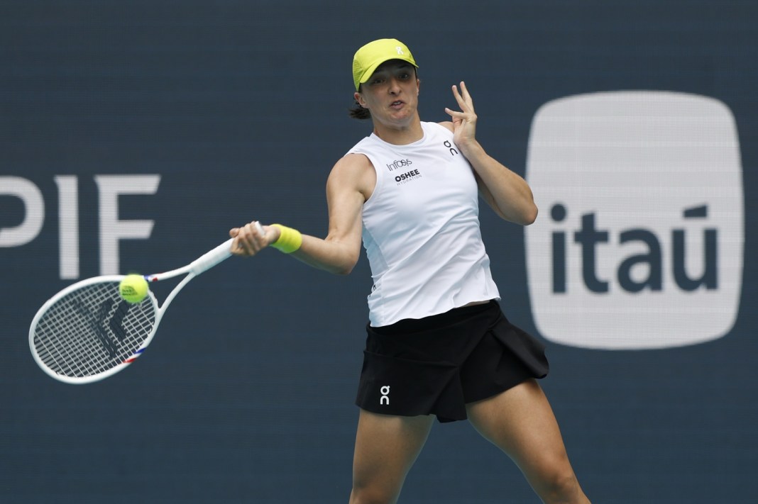 Iga Swiatek hits a forehand in a match at the 2025 Miami Open.