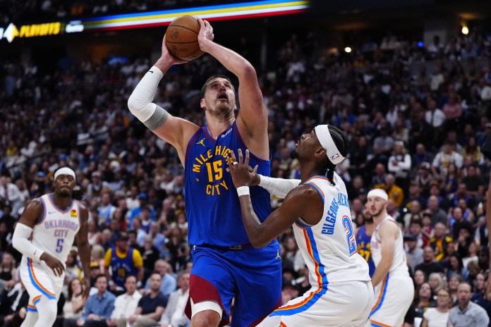Nuggets superstar Nikola Jokic goes up with a shot over Shai Gilgeous-Alexander during the 2024-25 NBA Playoffs.