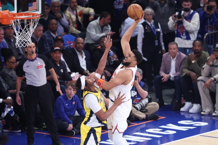New York Knicks center Karl-Anthony Towns (32) shoots against Indiana Pacers center Myles Turner (33)