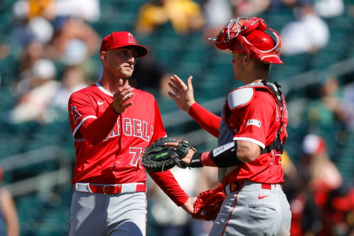Los Angeles Angels pitcher Kenley Jansen (74) and catcher Logan O'Hoppe (14) shake hands after the game against the Athletics at Sutter Health Park in West Sacramento, California, on May 22, 2025.