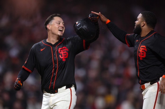 San Francisco Giants designated hitter Wilmer Flores (left) and Heliot Ramos celebrate their extra-inning win over the Athletics at Oracle Park in San Francisco, California, on May 17, 2025.