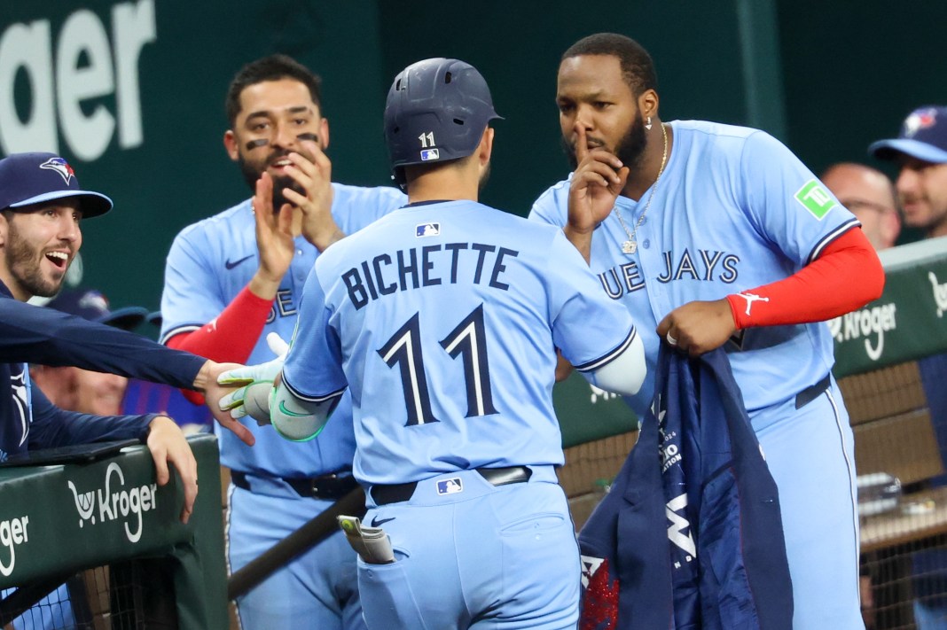 Toronto Blue Jays shortstop Bo Bichette (11) celebrates with first baseman Vladimir Guerrero Jr. (27) and right fielder George Springer (4) after hitting a two-run home run during the ninth inning of the game against the Texas Rangers at Globe Life Field in Arlington, Texas, on May 28, 2025.