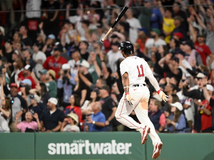 Boston Red Sox designated hitter Rafael Devers (11) hits a walk-off home run during the ninth inning of the game against the Atlanta Braves at Fenway Park in Boston, Massachusetts, on May 17, 2025.