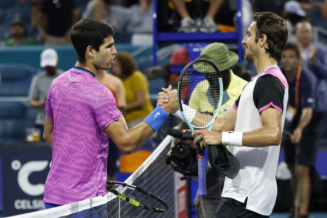 Carlos Alcaraz and Lorenzo Musetti meet at the net after a match at the 2024 Miami Open.