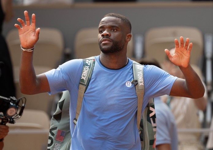 Frances Tiafoe says farewell to the crowd after losing to Lorenzo Musetti at the 2025 French Open at Roland Garros.
