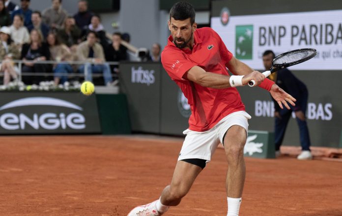 Novak Djokovic slices a shot against Alexander Zverev in the quarterfinals at the 2025 French Open in Roland Garros.