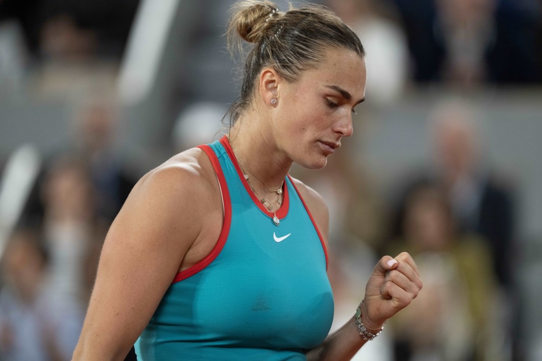 Aryna Sabalenka fist pumps after winning a point against Iga Swiatek at the 2025 French Open in Roland Garros.