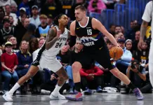 2025-26 NBA Playoffs Betting Guide: Picks, Previews and Predictions Nuggets superstar Nikola Jokic backs down Spurs guard Devin Vassell during the 2025-26 NBA season.
