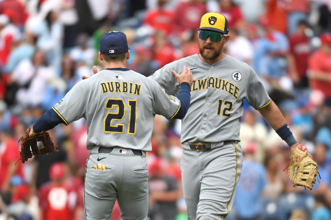 Milwaukee Brewers third baseman Caleb Durbin (21) and first baseman Rhys Hoskins (12) celebrate their win against the Philadelphia Phillies at Citizens Bank Park in Philadelphia, Pennsylvania, on June 1, 2025.