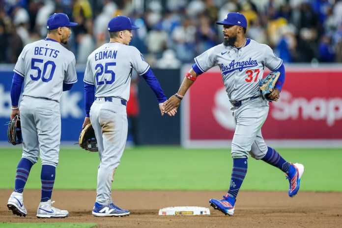 Los Angeles Dodgers right fielder Teoscar Hernandez (37) celebrates with second baseman Tommy Edman (25) after defeating the San Diego Padres at Petco Park in San Diego, California, on June 9, 2025.