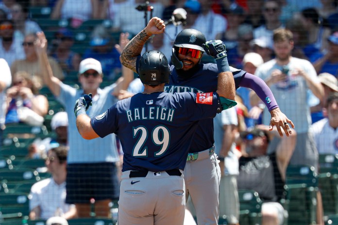 Seattle Mariners designated hitter Cal Raleigh (29) celebrates with shortstop J.P. Crawford (3) after hitting a two-run home run against the Chicago Cubs during the first inning at Wrigley Field in Chicago, Illinois, on June 22, 2025. Mandatory Credit: Kamil Krzaczynski-Imagn Images.