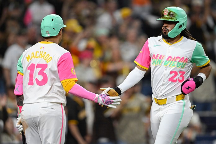 San Diego Padres right fielder Fernando Tatis Jr. (23) is congratulated by Manny Machado (13) after scoring during the sixth inning of the game against the Pittsburgh Pirates at Petco Park in San Diego, California, on May 30, 2025.