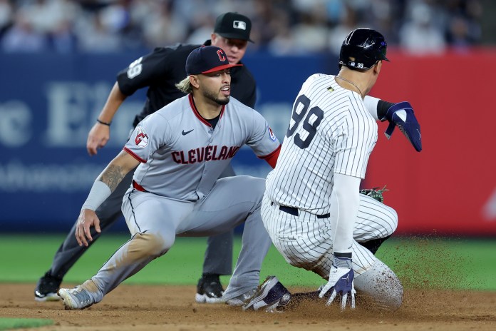 Cleveland Guardians shortstop Gabriel Arias (13) tags out New York Yankees right fielder Aaron Judge (99) trying to steal second base during the eighth inning at Yankee Stadium in Bronx, New York, on June 3, 2025.