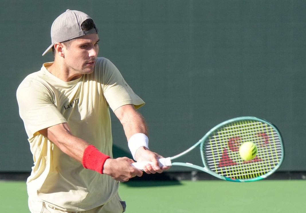 Marcos Giron hits a backhand against Casper Ruud at Indian Wells in 2025.