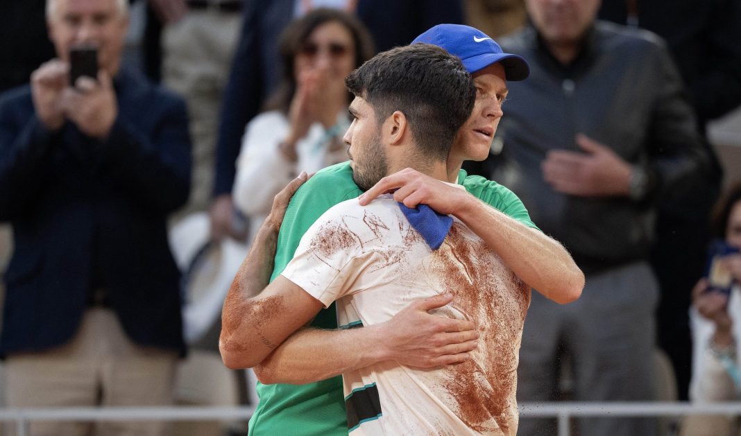 Carlos Alcaraz and Jannik Sinner meet at the net after the 2025 French Open final at Roland Garros.