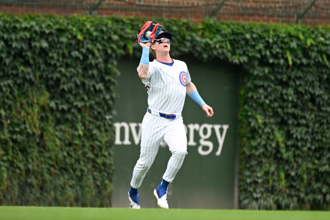 Chicago Cubs outfielder Pete Crow-Armstrong (4) catches a fly ball hit by first baseman Justin Turner (3) during the first inning at Wrigley Field on July 20, 2025, in Chicago, Illinois. Mandatory Credit: Matt Marton-Imagn Images.