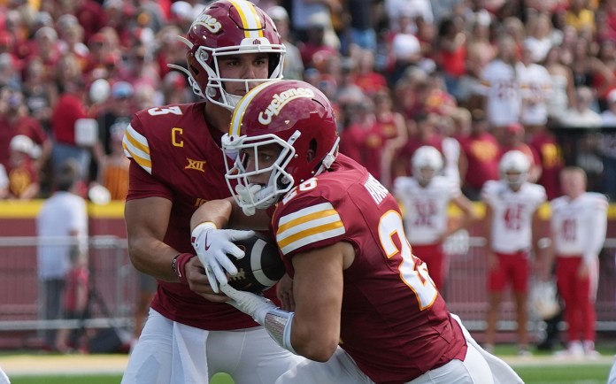 Iowa State quarterback Rocco Becht hands the ball off to Carson Hansen in a meeting with South Dakota during the 2025 college football season.