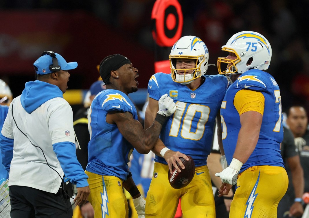 Chargers quarterback Justin Herbert celebrates a win over the Chiefs with his teammates in the 2025 season.