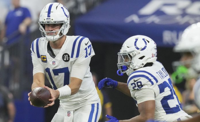 Colts quarterback Daniel Jones hands the ball off to Jonathan Taylor during the 2025 NFL season.