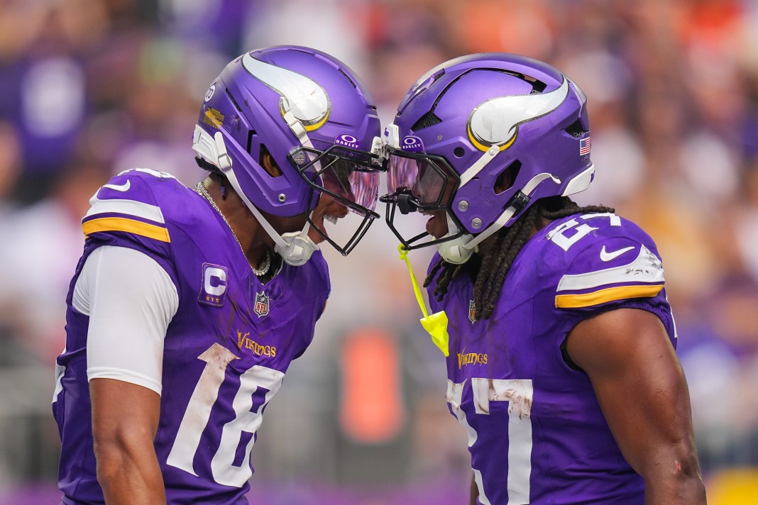 Vikings players Justin Jefferson and Jordan Mason celebrate a play against the Bengals during the 2025 NFL season.