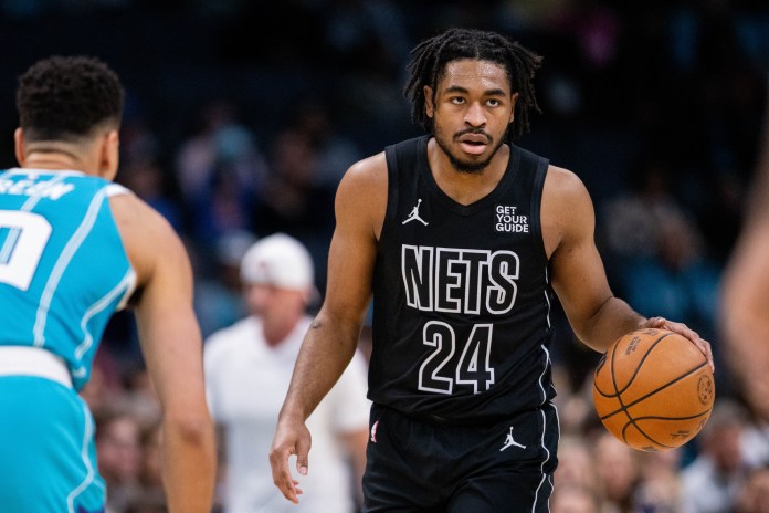 Nets guard Cam Thomas dribbles against the Hornets during the 2024-25 NBA season.