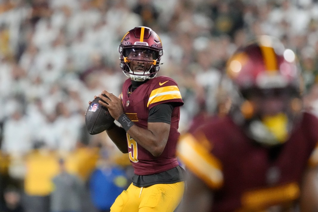 Commanders star Jayden Daniels looks to throw against the Packers during the 2025 NFL season.