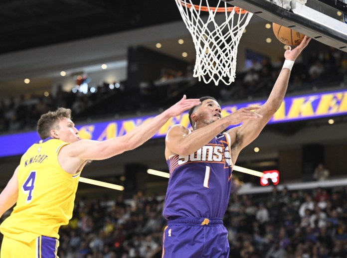 Suns superstar Devin Booker finishes at the rim against the Lakers during the 2025-26 NBA preseason.