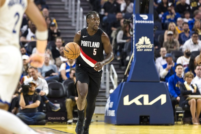 Blazers guard Jrue Holiday brings the ball up against the Warriors during the 2025-26 NBA preseason.