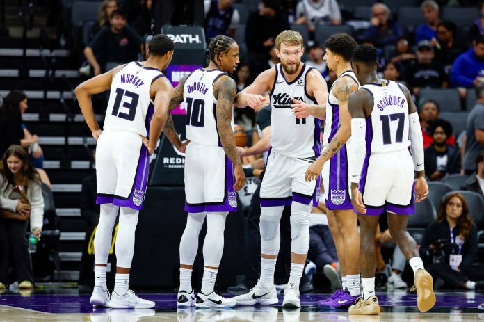 Kings All-Star Domantas Sabonis leads a huddle in a 2025-26 NBA preseason meeting with the Raptors.