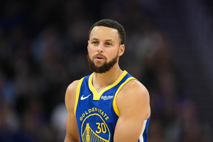 Warriors star Stephen Curry looks on against the Suns during the 2025-26 NBA season.