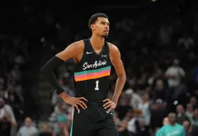 NBA Picks & Predictions Today (Nov. 14): Best Bets on Sides & Totals Spurs star Victor Wembanyama looks on against the Warriors during the 2025-26 NBA season.