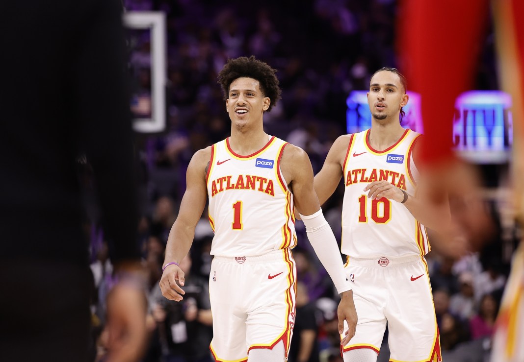 Hawks forwards Jalen Johnson and Zaccharie Risacher walk during a game against the Kings in the 2025-26 NBA season.