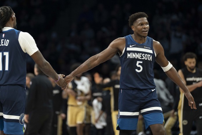 Timberwolves star Anthony Edwards high five Naz Reid during the 2025-26 NBA season.