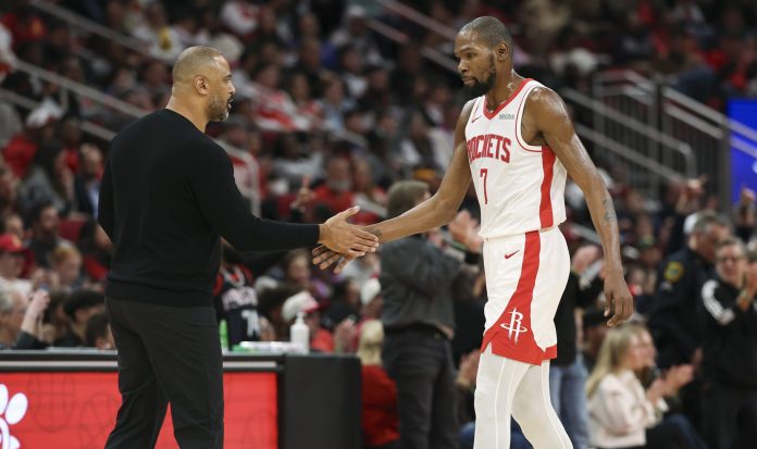 Rockets star Kevin Durant high fives coach Ime Udoka during a meeting with the Suns in the 2025-26 NBA season.