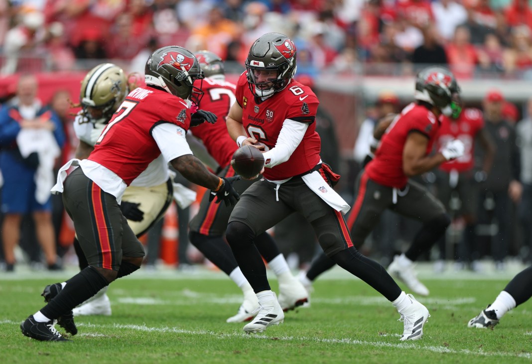 NFL: New Orleans Saints at Tampa Bay Buccaneers Buccaneers quarterback Baker Mayfield hands the ball to Bucky Irving in a meeting with the Saints during the 2025 NFL season.